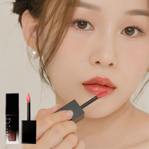 Plumping lip oil in 18 Cozy Pink with dropper applicator on plain white background