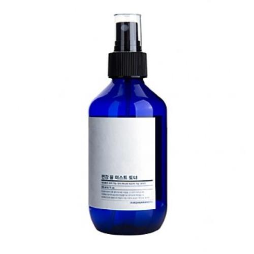 Facial cleansing bar in pump dispenser on plain white background