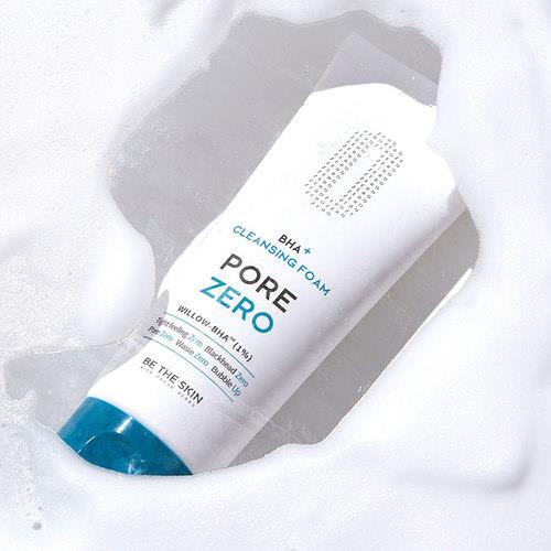 Exfoliating cleansing foam in 3g container in pump dispenser on plain white background