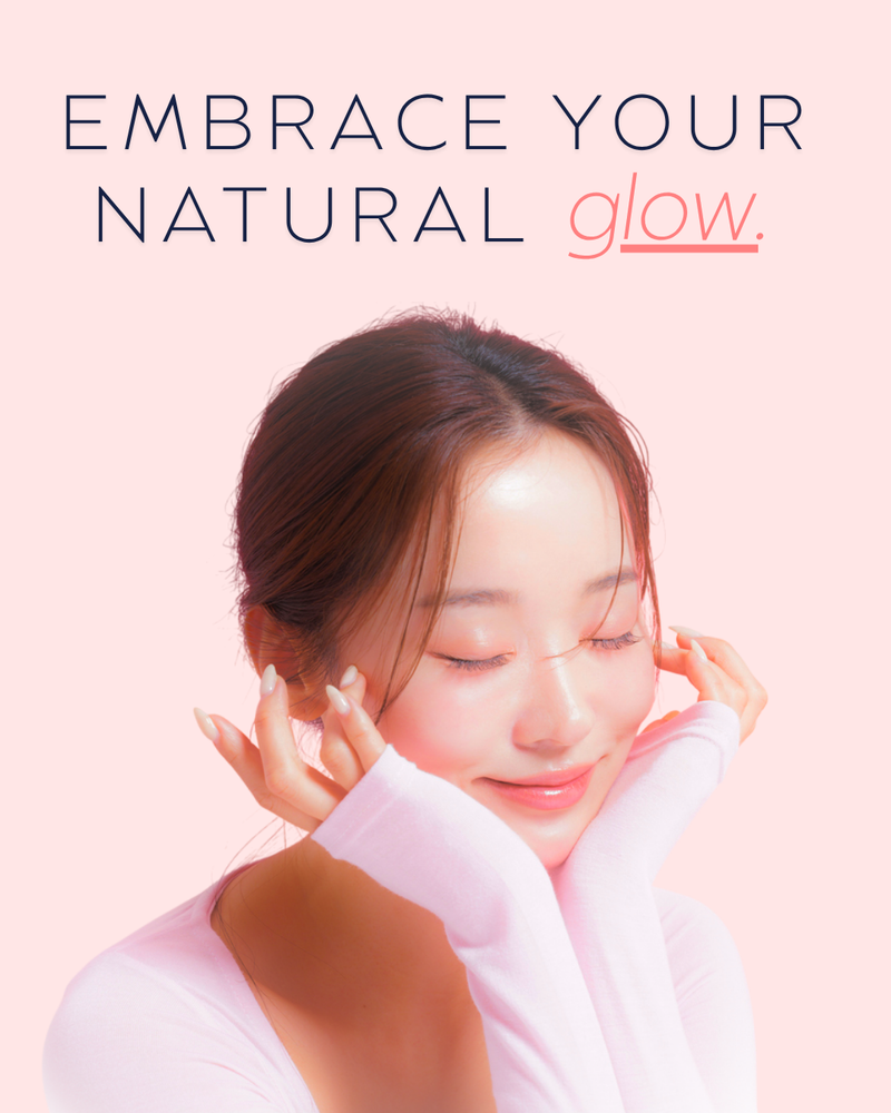 K‑Beauty model smiling against a soft pastel pink backdrop, showcasing gentle skincare glow