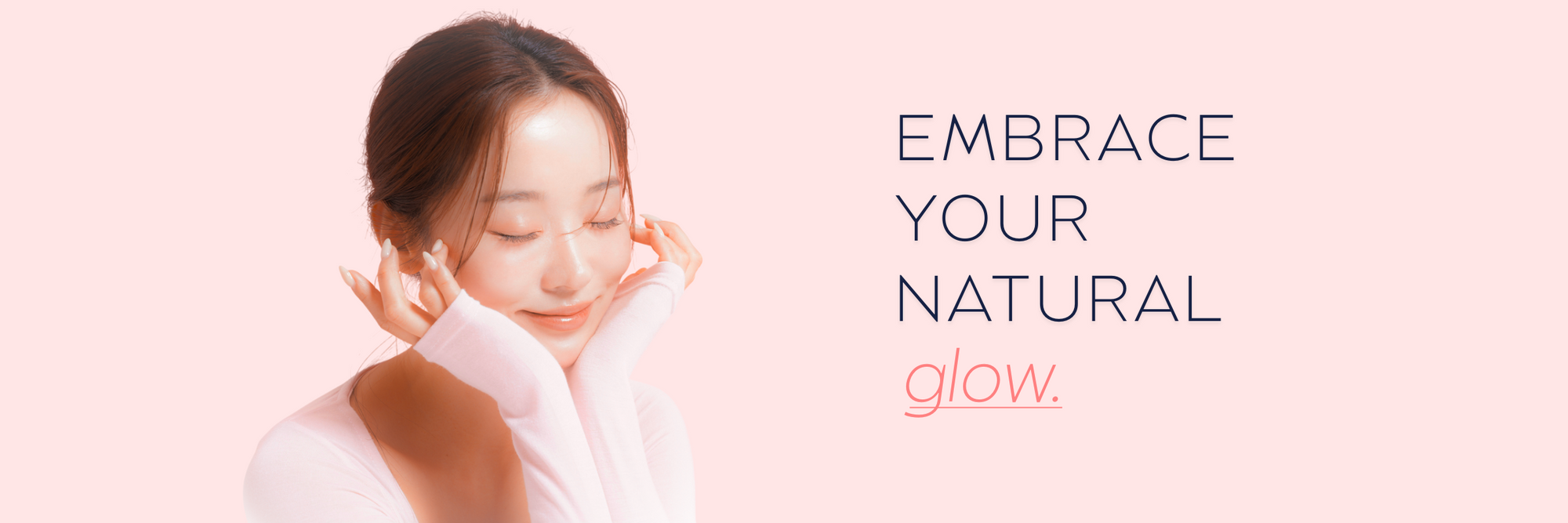 K‑Beauty model smiling against a soft pastel pink backdrop, showcasing gentle skincare glow