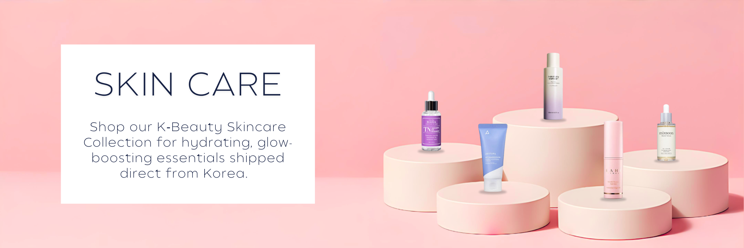 K‑Beauty makeup collection featuring lipsticks, foundations, and glow-enhancing products on a soft pink display